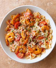 Farfalle pasta with shrimps, tomatoes and cheese. Healthy eating. Italian food.