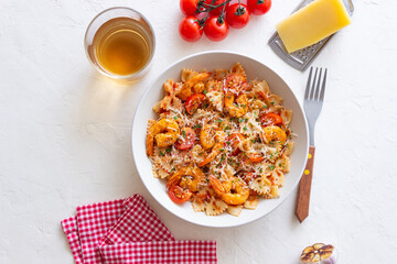 Farfalle pasta with shrimps, tomatoes and cheese. Healthy eating. Italian food.