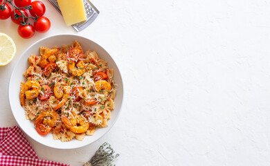 Farfalle pasta with shrimps, tomatoes and cheese. Healthy eating. Italian food.