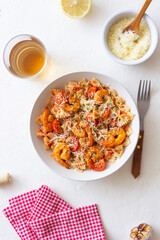 Farfalle pasta with shrimps, tomatoes and cheese. Healthy eating. Italian food.