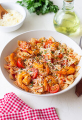 Farfalle pasta with shrimps, tomatoes and cheese. Healthy eating. Italian food.