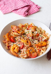 Farfalle pasta with shrimps, tomatoes and cheese. Healthy eating. Italian food.