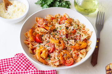 Farfalle pasta with shrimps, tomatoes and cheese. Healthy eating. Italian food.