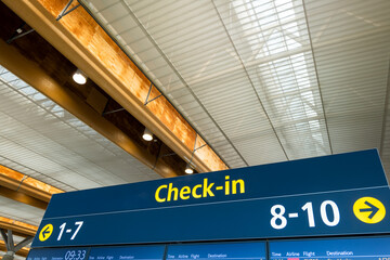  Airport flight boarding information screen and check-in counter sign in airport
