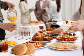 Coworkers having business lunch in restaurant, closeup