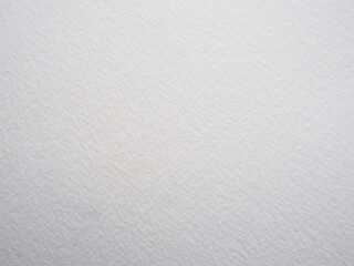 Grungy white watercolor paper backdrop with rough textured surface for design projects