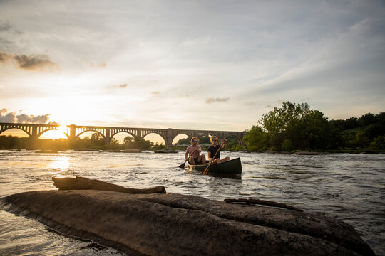 Couple canoeing on a river.