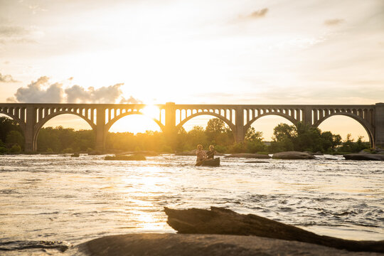 Couple canoeing on a river.