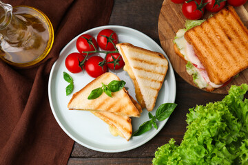 Pieces of toasted bread with melted cheese served on wooden table, top view