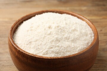 Coconut flour in bowl on table, closeup