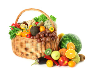 Many different fruits and vegetables in wicker basket isolated on white