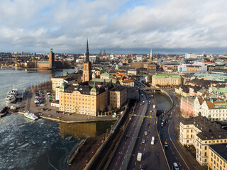 Naklejka premium Stockholm, Sweden: Aerial view of Stockholm Gamla Stan old town and the Centralbron road bridge on the lake Malaren in Sweden capital city in winter.