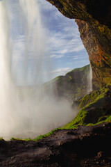 Behind a Waterfall in Island - Waterfall with Mountains, Sky and Clouds