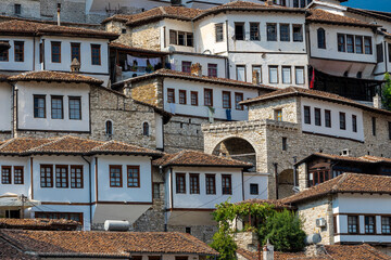 Naklejka premium Sunset over the UNESCO town of Berat on the Osum River in Albania and known for its white Ottoman houses also called the city of One Over One Windows and built against the hill side below the citadel