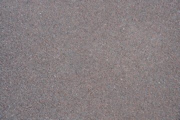 gray background, texture of rubber crumb coating for sports and children's playgrounds, paths