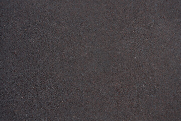 gray background, texture of rubber crumb coating for sports and children's playgrounds, paths