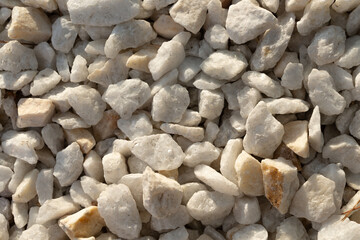 A close-up image of white gravel stones, ideal for backgrounds, textures, and construction-related themes.