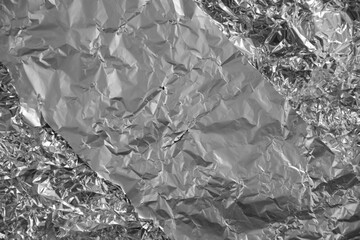 Processed collage of shiny metal silver gray foil crumpled packaging material texture