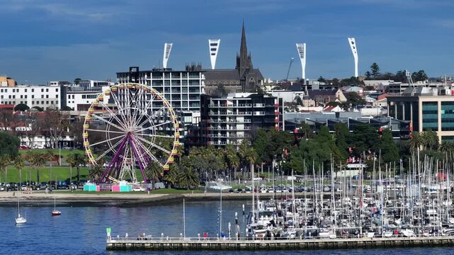 Aerial view of a large ferris wheel in a bustling city harbor GEELONG