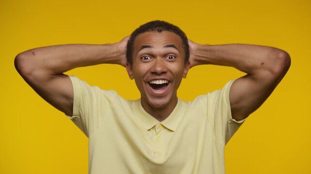Excited Man Celebrating on Yellow Background