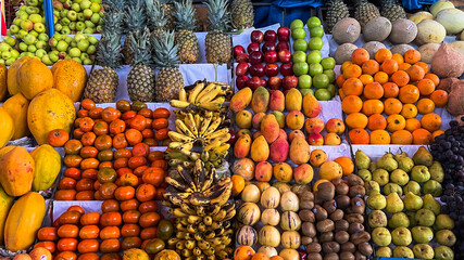 Vibrant scene, overflowing with exotic, colorful fruits.
The bustling market stalls display a rich variety of fresh produce, showcasing the region's diverse and abundant harvests.