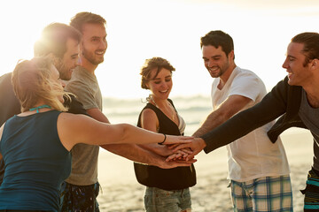 People, friends and hands together for team building by beach on travel, vacation or break. Group, relax and solidarity for fun in summer picnic, wellness and outdoor adventure at ocean in Greece