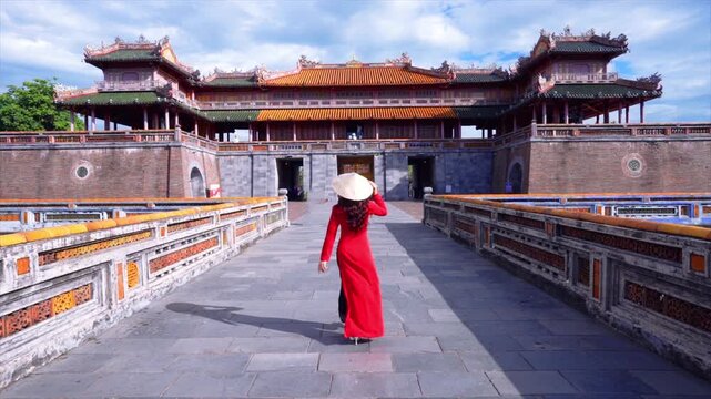 Elegant Girl in Ao Dai dress Entering Imperial Citadel Hue: Graceful Presence Amidst Hue's Royal Legacy, co do Hue, cung dinh Hue, Vietnam.