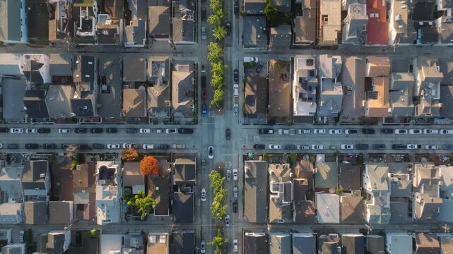 A detailed aerial perspective of residential streets in Newport Beach, CA, reveals a wellstructured urban setting with treelined avenues and aligned houses, showcasing a harmonious city landscape
