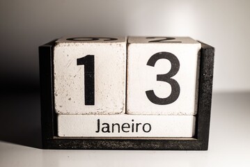 Close-up of a wooden block calendar displaying the 13th of January.