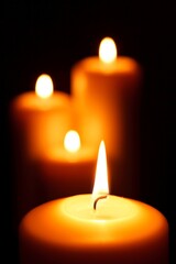 Burning Candles in Blackness - Grouped Together on Dark Background in 4K Video
