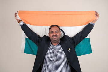 A proud gentleman holding the Indian flag, symbolizing patriotism and national pride.