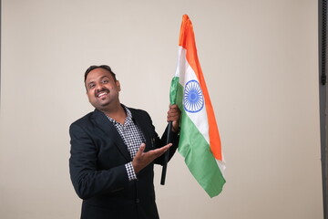 A proud gentleman holding the Indian flag, symbolizing patriotism and national pride.