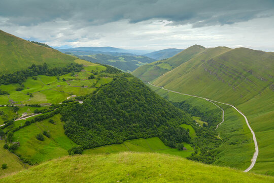 Green mountains with farms in the Pasiegos valleys, between Vega de Pas and Espinosa de llos Monteros in Burgos, by the Ojo Guare&ntilde;a mountain pass