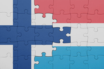 puzzle with the colourful national flag of luxembourg and flag of finland.