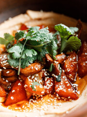 delicious dish with juicy teriyaki chicken, fresh vegetables, and fragrant herbs on a beautiful plate in a cozy nice restaurant