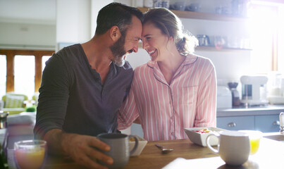 Happy couple, love or eating breakfast together with love, care or juice in meal in home kitchen. Romantic people, forehead or morning snack for bonding, support or food in healthy marriage for trust