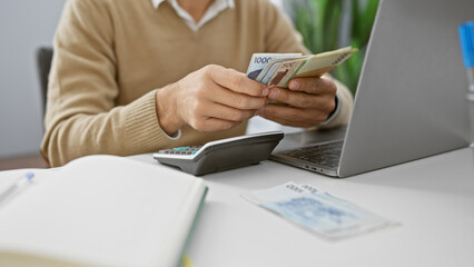 Man counts euros in well-lit office, indicating business, finance, and european currency handling.