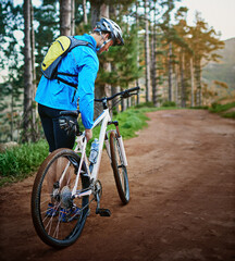 Walking, forest and cyclist with flat tire on bicycle for problem, maintenance or repair. Nature,...