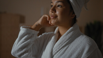 A young, attractive hispanic woman with brunette hair enjoys a moment of relaxation at an indoor...
