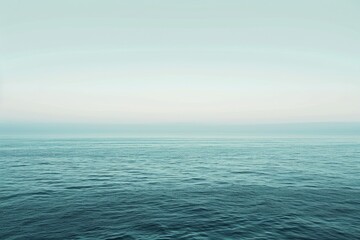 Obraz premium A minimalist seascape with an expansive horizon stretching towards infinity. The image captures the vastness of the open ocean, utilizing calming tones and soft gradients reminiscent of the seascapes
