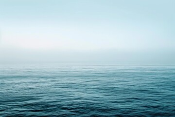 Obraz premium A minimalist seascape with an expansive horizon stretching towards infinity. The image captures the vastness of the open ocean, utilizing calming tones and soft gradients reminiscent of the seascapes