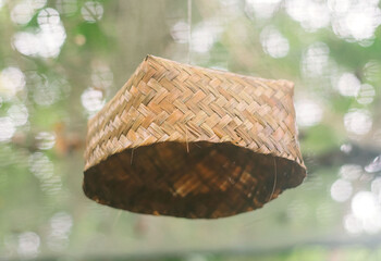 a hanging Besek, a traditional Indonesian container made of woven bamboo