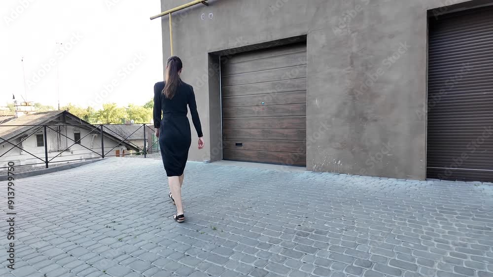 Canvas Prints Woman walking in the city wearing elegant black dress