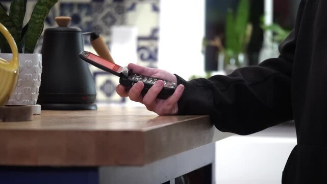 Person opens flip phone in slow motion on kitchen counter
