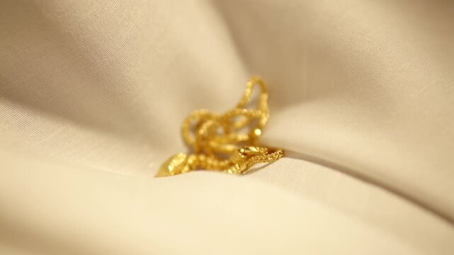 Gold Wedding Necklace dropped on velvet cloth. Jewelry for Weddings and engagements.