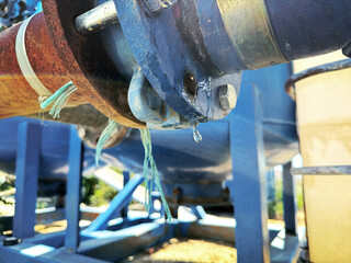 Close-up view of water leak from a large pipe joint
