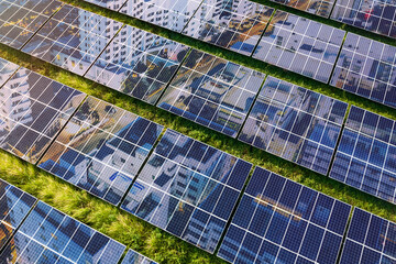 An image of a vibrant city superimposed on a solar PV farm. Concept of a city or nation powered by renewables and solar energy.