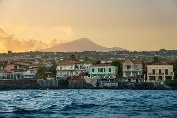 Fototapeta premium Catania coastline with Mount Etna at sunset, Sicily coastal landscape from sea