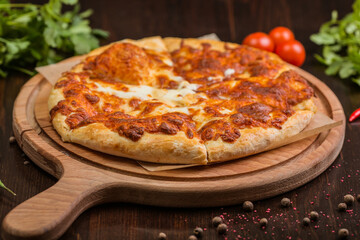 khachapuri with sulguni cheese, herbs and egg on a wooden surface. Georgian pie. Georgian pizza
