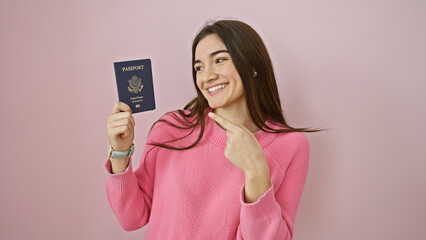 Smiling young woman holding american passport against pink background, depicting travel readiness.